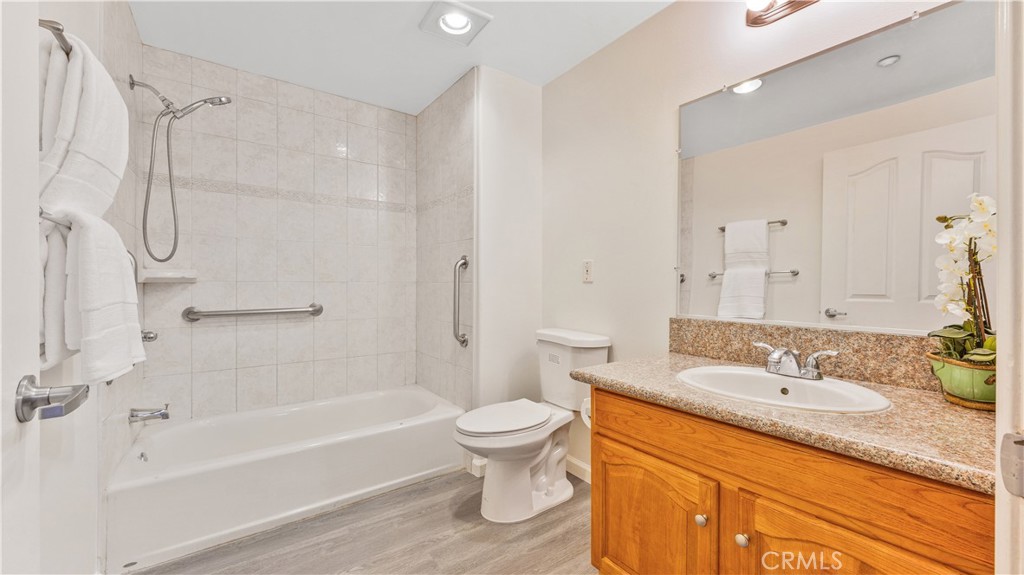 421 South Garfield Avenue, Unit 10 Monterey Park, CA 91754 - Photo 16 of 20 a bathroom with a granite countertop sink a toilet and a bathtub
