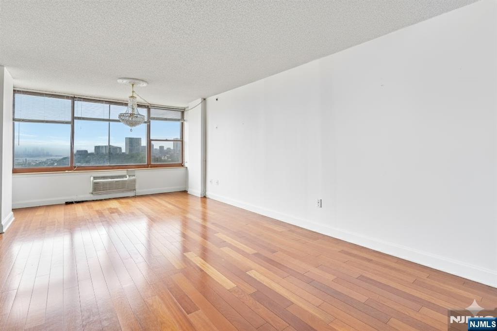 100 Old Palisade Road, Unit 1610 Fort Lee, NJ 07024 - Photo 4 of 21 a view of empty room with wooden floor and fan