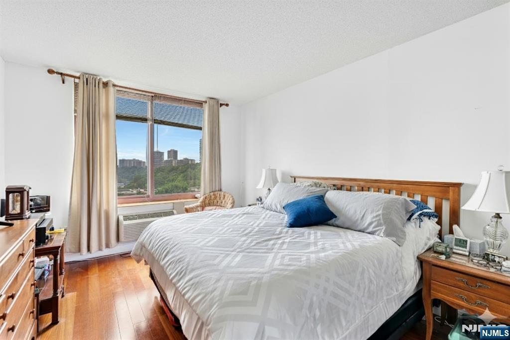 100 Old Palisade Road, Unit 1610 Fort Lee, NJ 07024 - Photo 9 of 21 a bedroom with a bed and a large window