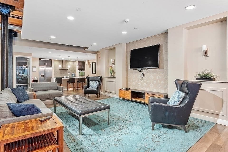 130 John Street, Unit 213 Lowell, MA 01852 - Photo 11 of 17 a living room with furniture and a flat screen tv