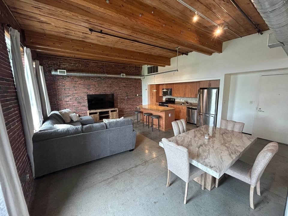 130 John Street, Unit 213 Lowell, MA 01852 - Photo 14 of 17 a living room with furniture and a fireplace