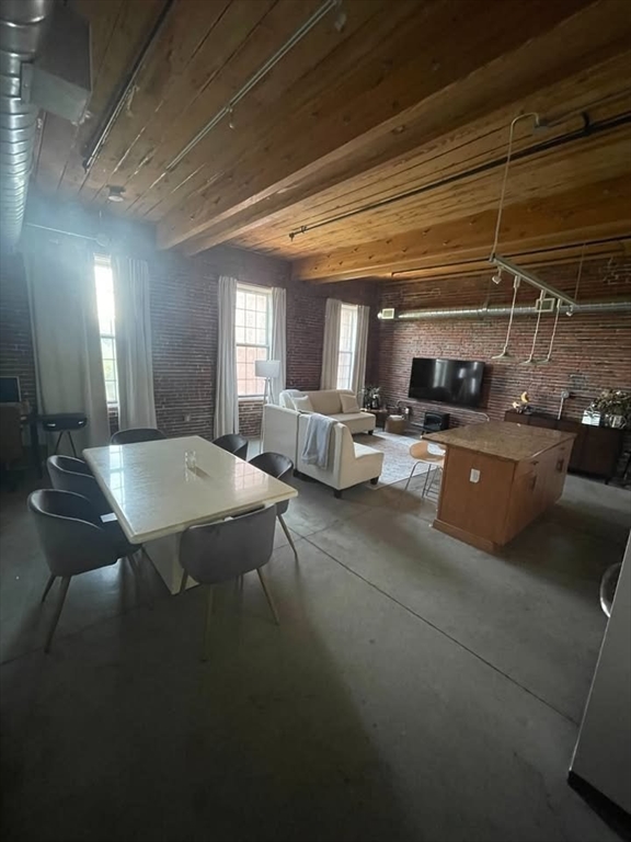 130 John Street, Unit 213 Lowell, MA 01852 - Photo 4 of 17 a open kitchen with stainless steel appliances granite countertop a stove a sink dishwasher and cabinets