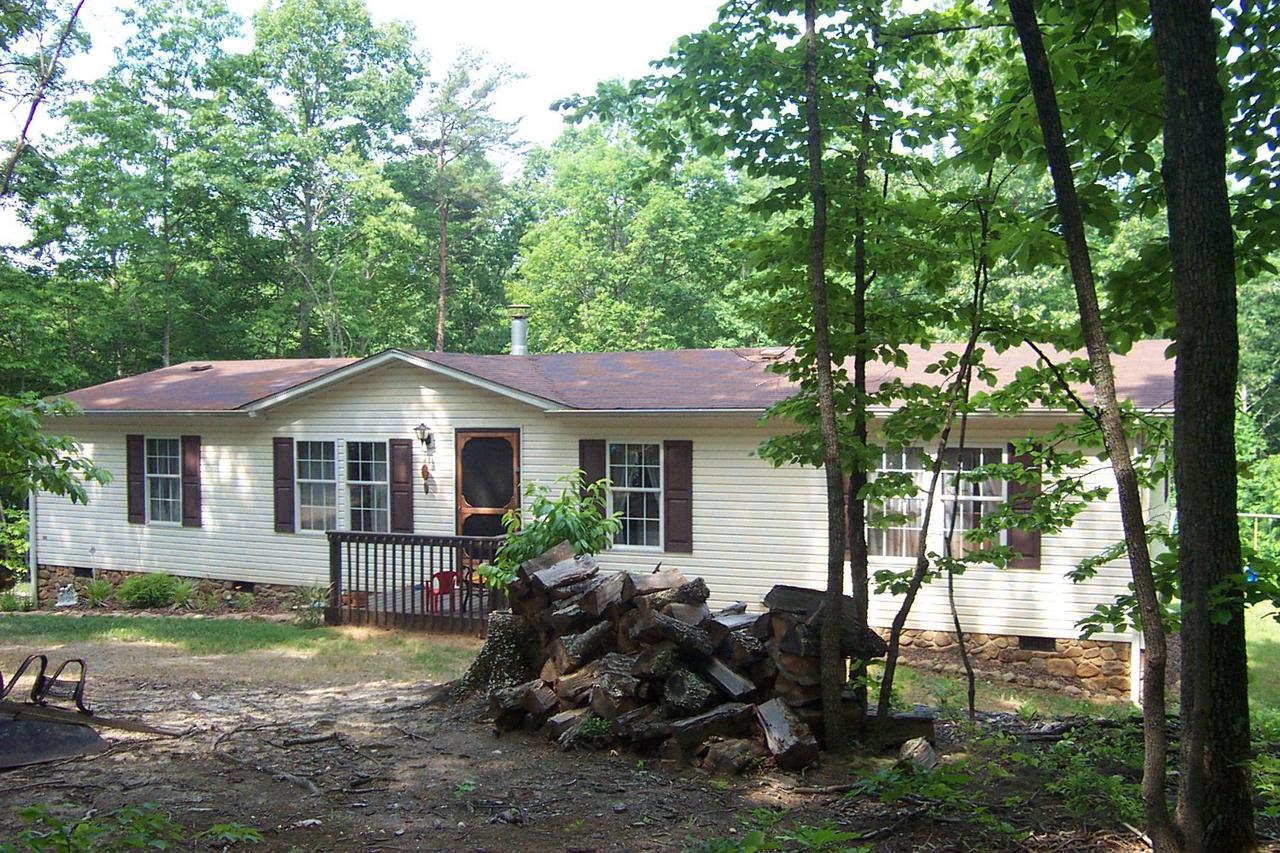 2775 Sandy Level Road Goodview, VA 24095 - Photo 2 of 6 a backyard of a house with yard and outdoor seating