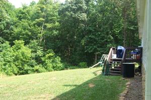 2775 Sandy Level Road Goodview, VA 24095 - Photo 6 of 6 a view of a garden with a bench