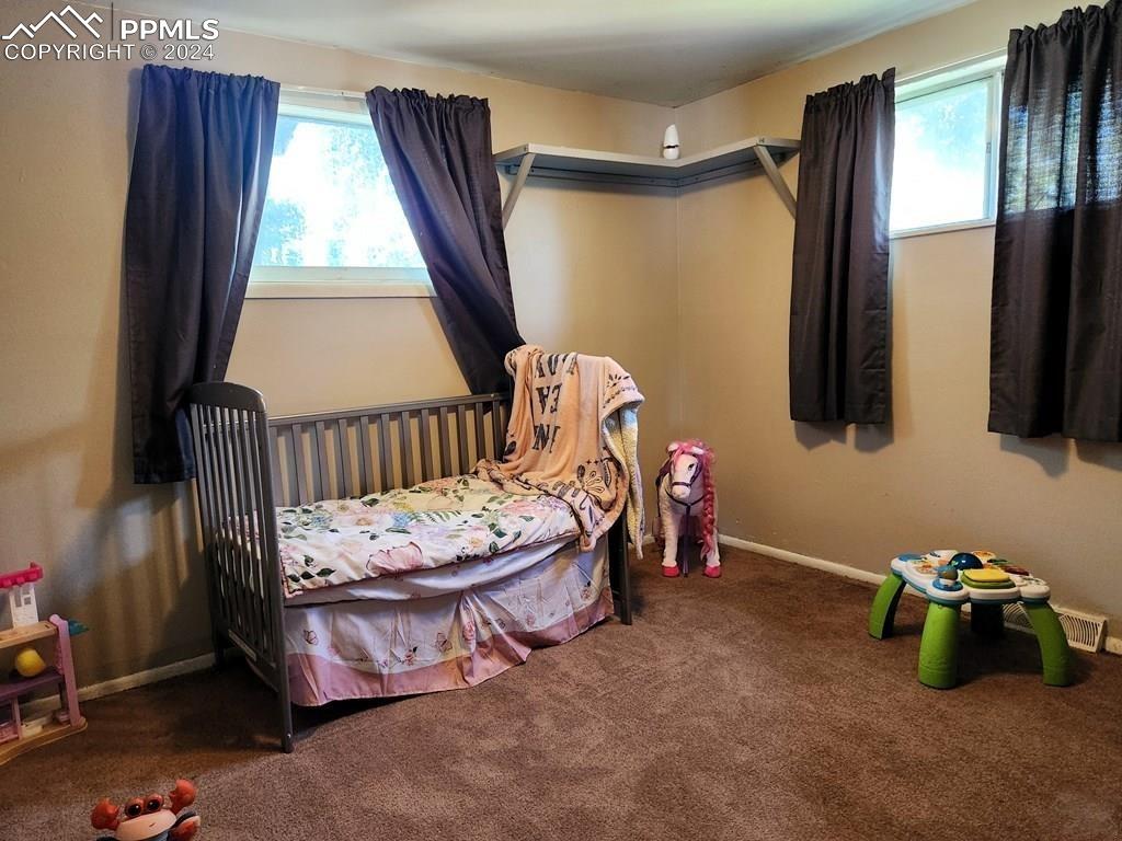 1509 Kickapoo Road Pueblo, CO 81001 - Photo 13 of 24 a bedroom with furniture and a window