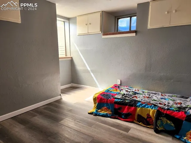 a bedroom with a bed and window