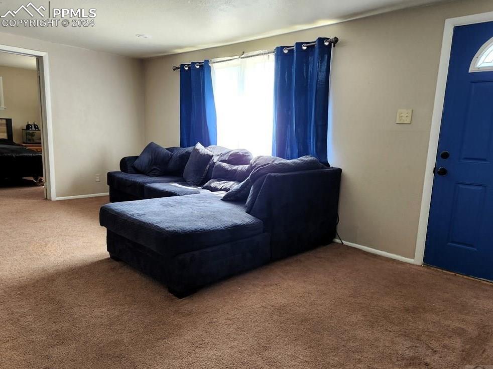 1509 Kickapoo Road Pueblo, CO 81001 - Photo 2 of 24 a living room with furniture and a window
