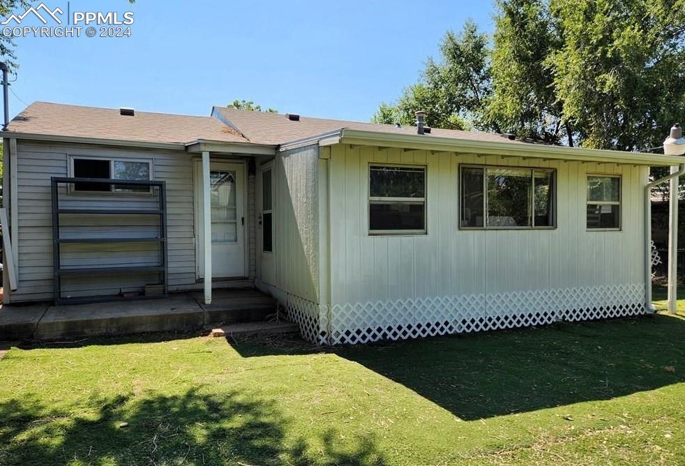 1509 Kickapoo Road Pueblo, CO 81001 - Photo 22 of 24 a front view of a house with a yard