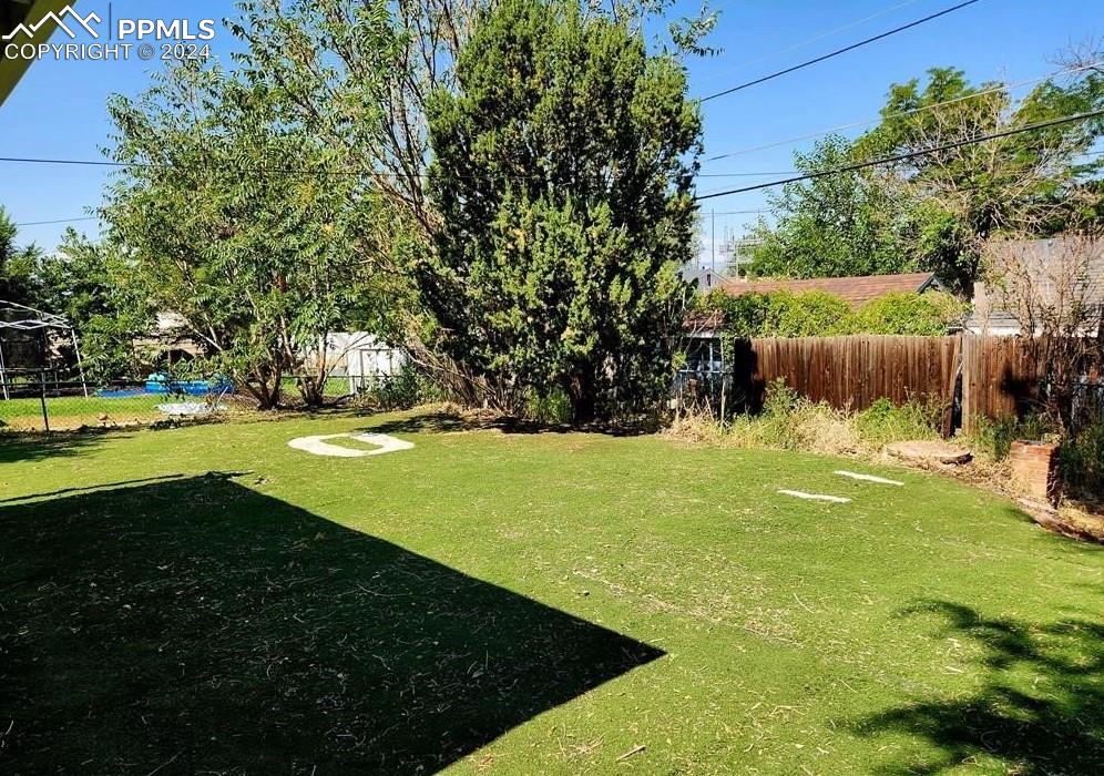 1509 Kickapoo Road Pueblo, CO 81001 - Photo 23 of 24 a view of a golf ground with huge green field and large trees