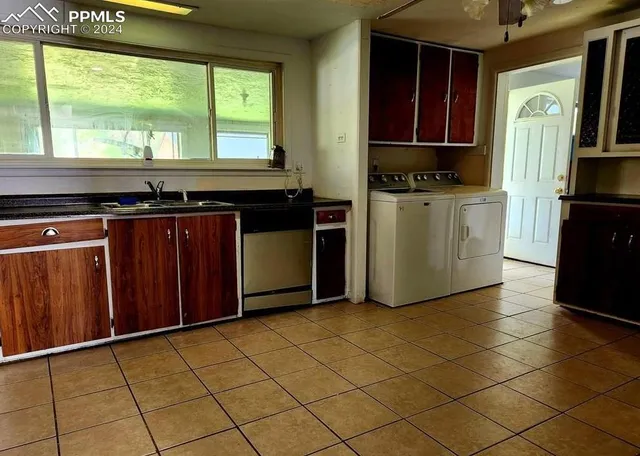 a kitchen with stainless steel appliances a stove a refrigerator and a sink