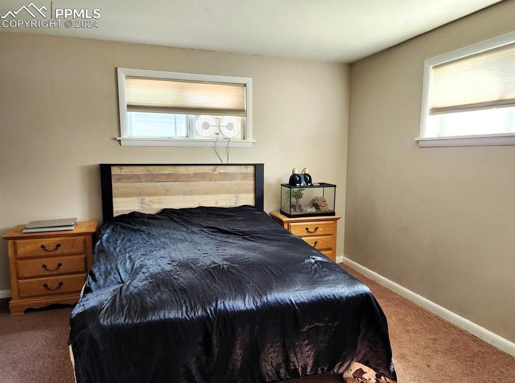 1509 Kickapoo Road Pueblo, CO 81001 - Photo 9 of 24 a bedroom with a bed and a window