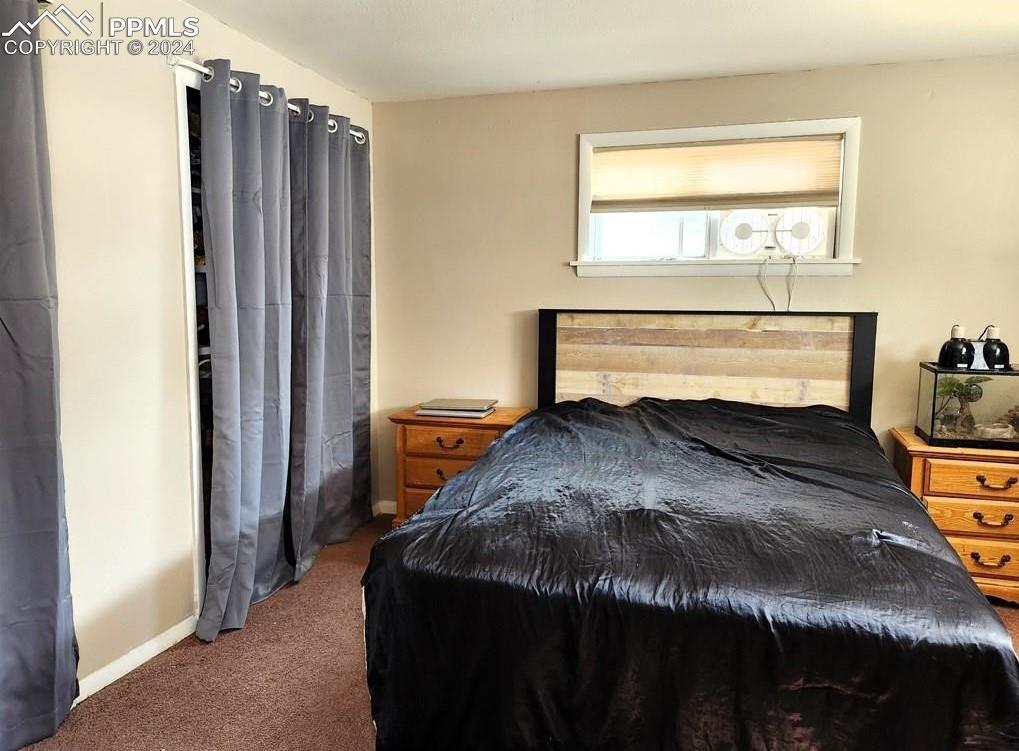 1509 Kickapoo Road Pueblo, CO 81001 - Photo 10 of 24 a bedroom with a bed and a window