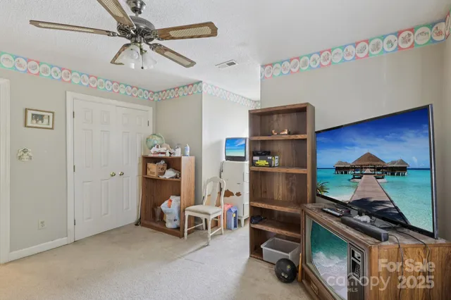 a room with furniture and a fan