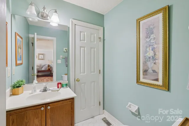 a bathroom with a sink vanity and a mirror