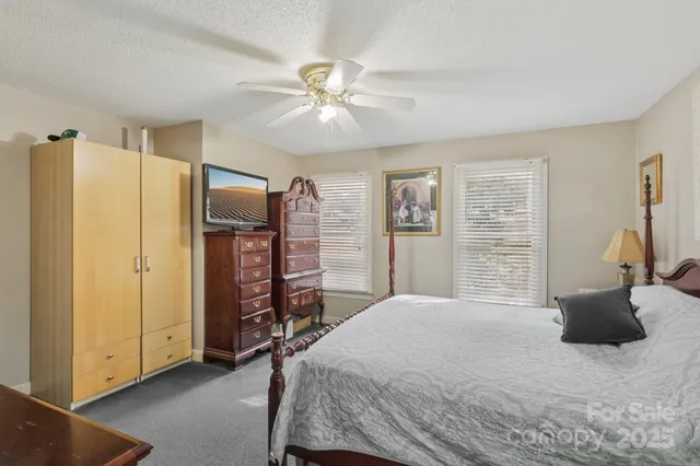a bedroom with a bed dresser and a large mirror