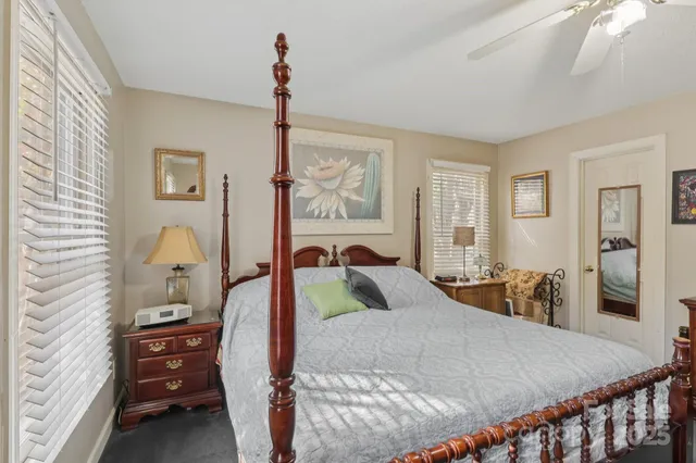 a bedroom with a bed and a dresser with mirror