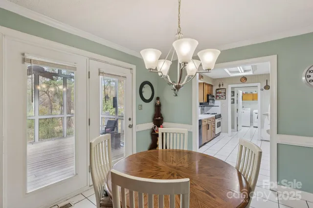 a view of a dining room with furniture and a chandelier