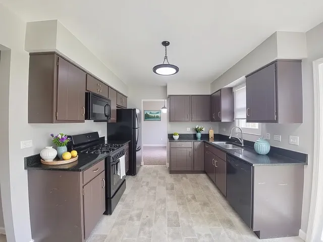 a kitchen with a sink stove and refrigerator