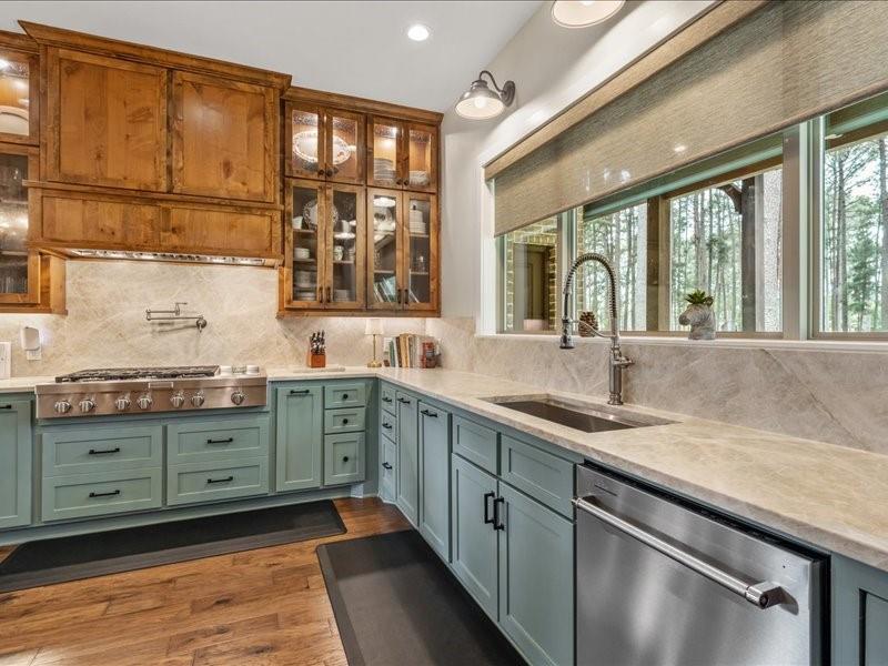 8595 Toler Pointe Larue, TX 75770 - Photo 18 of 40 Vintage Rustic style design in the kitchen with top of the line stainless appliances and large sink. Views of the pine trees makes washing dishes relaxing. Top of the line quartzite counters and backsplash.