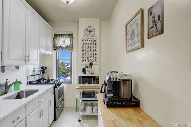 a kitchen with a sink cabinets and window