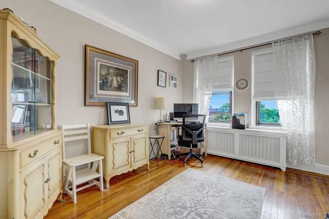 a view of a livingroom with workspace and a window