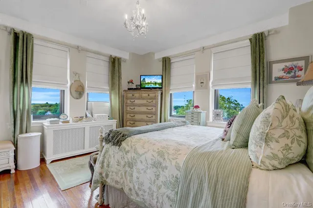 a bed sitting in a spacious bedroom next to a window