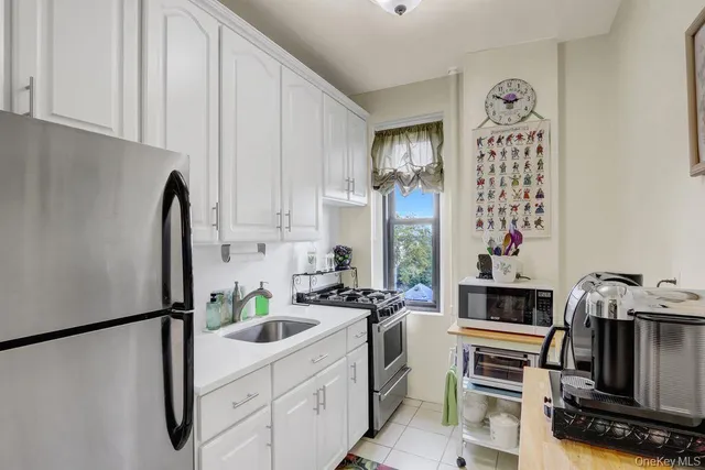 a kitchen with stainless steel appliances a refrigerator sink and stove