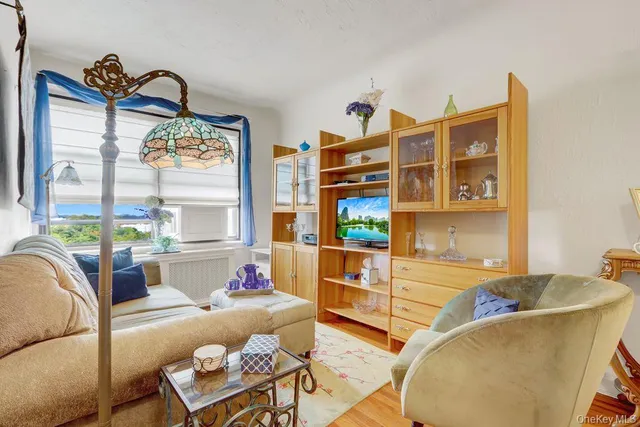 a living room with furniture fireplace and a large window