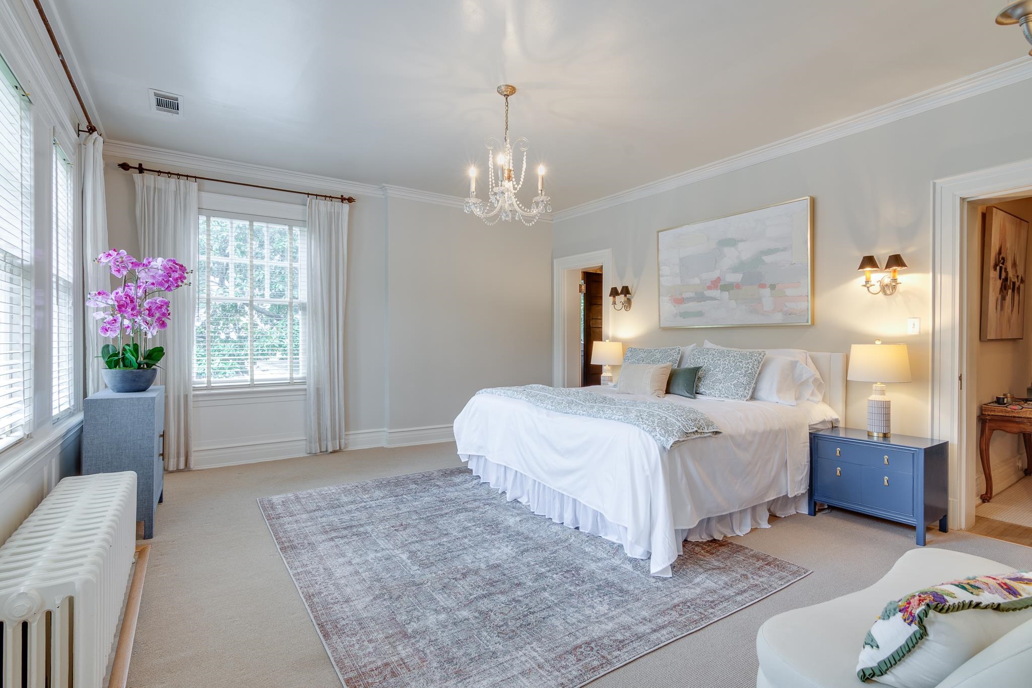 2221 Poplar Avenue Memphis, TN 38104 - Photo 18 of 40 a spacious bedroom with a bed chandelier and a window