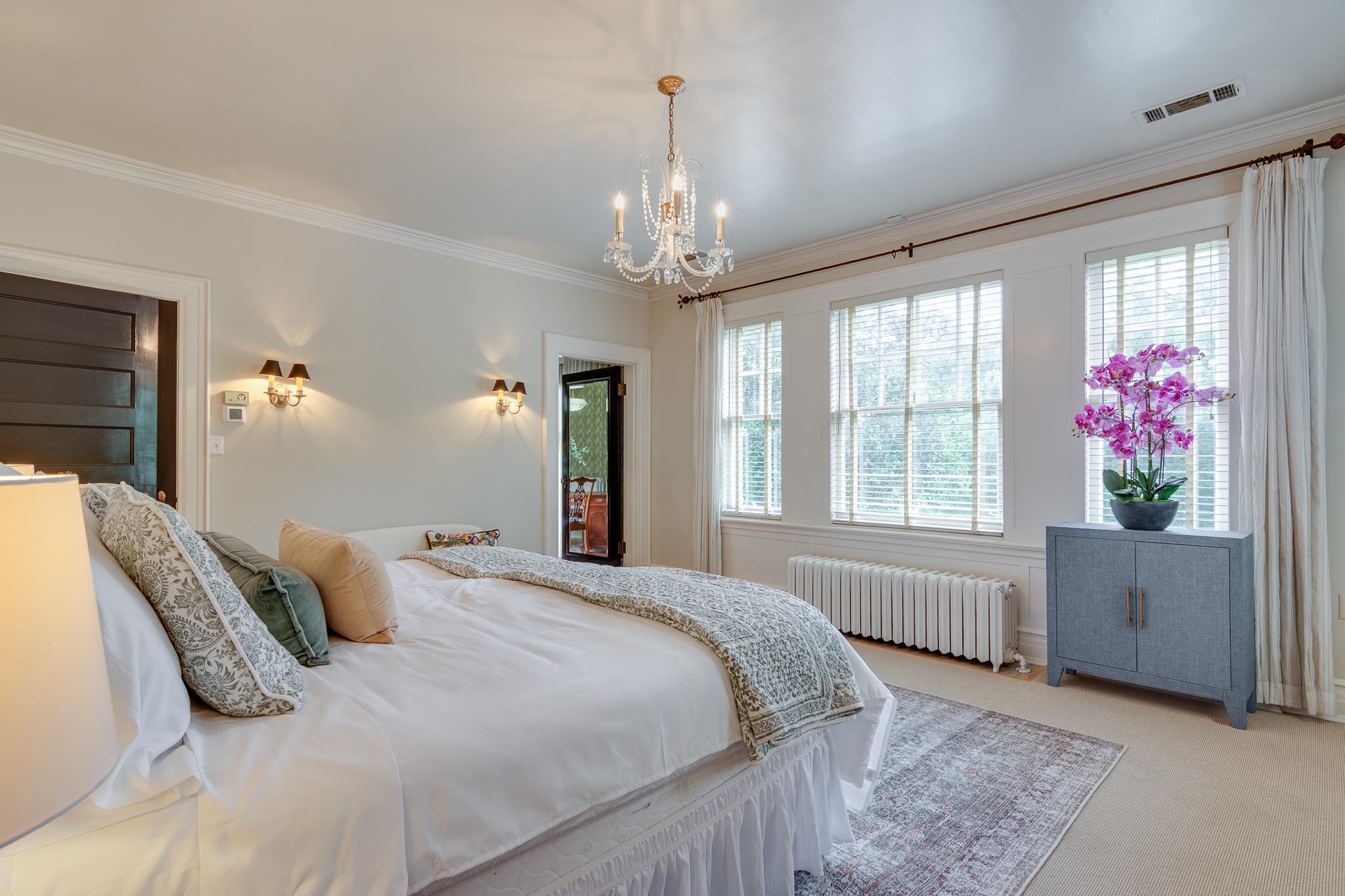 2221 Poplar Avenue Memphis, TN 38104 - Photo 19 of 40 a bedroom with a large bed and a chandelier