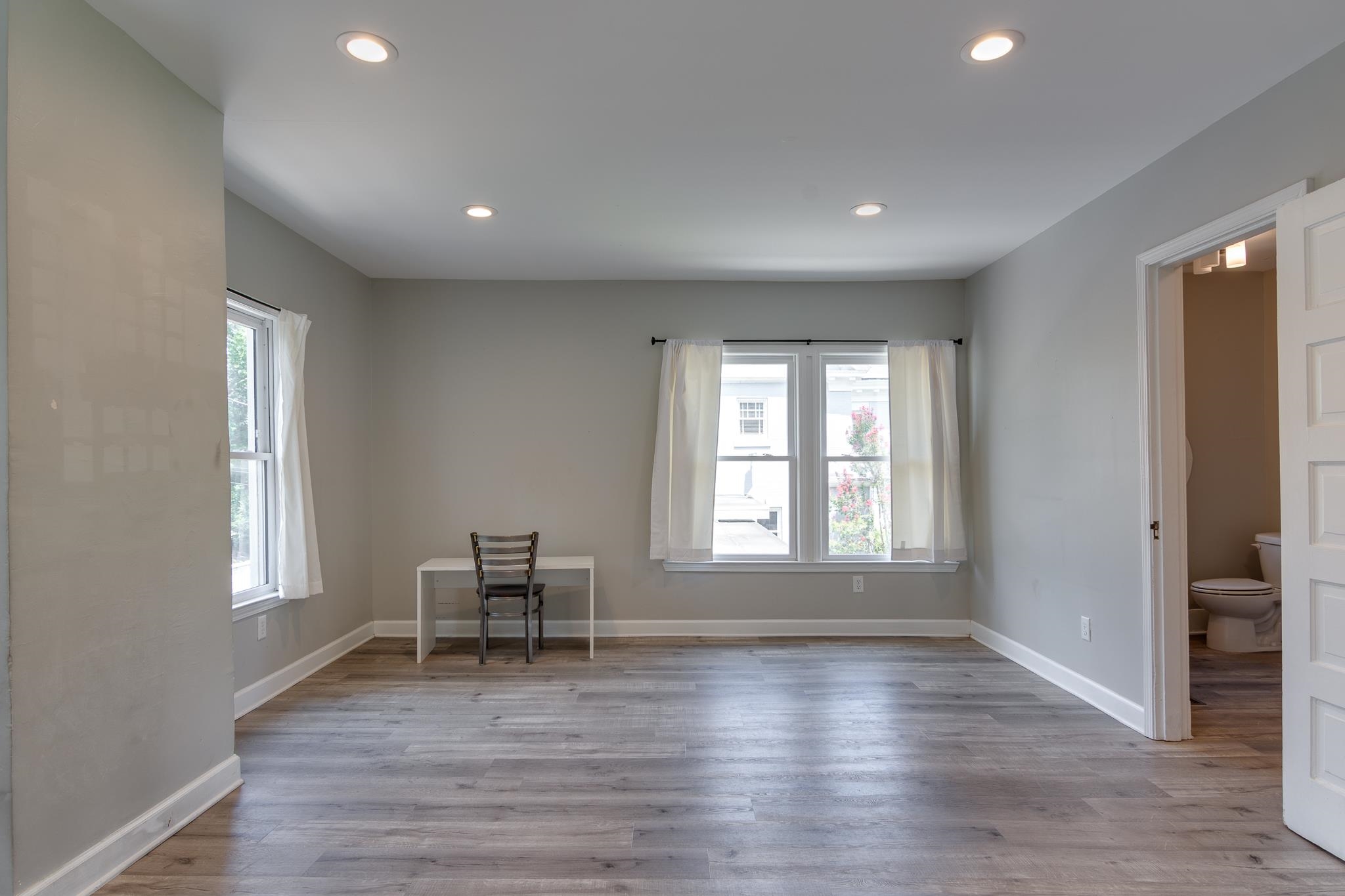 2221 Poplar Avenue Memphis, TN 38104 - Photo 37 of 40 an empty room with wooden floor and a window