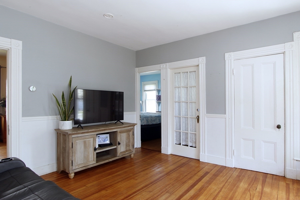 2 High Street Middleboro, MA 02346 - Photo 20 of 41 a living room with a flat screen tv and a fireplace