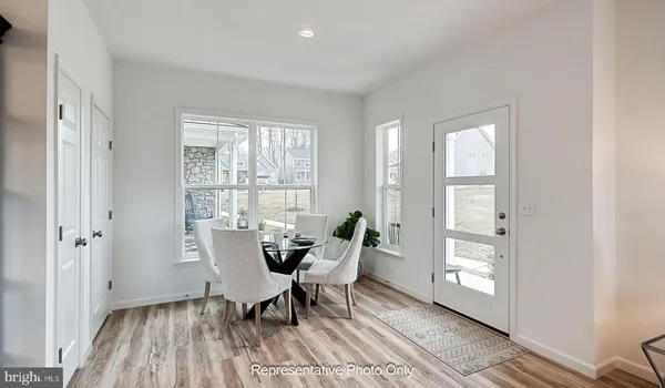 a dining room with furniture and wooden floor