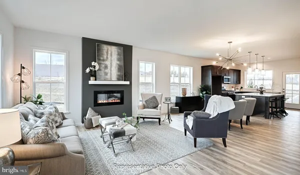 a living room with furniture kitchen view and a fireplace