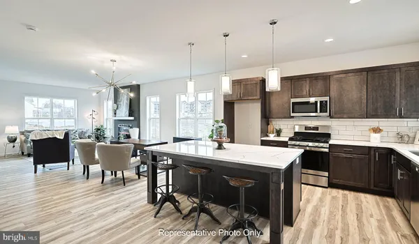 a kitchen with a table chairs refrigerator and microwave