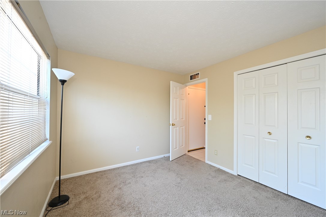 28140 Detroit Road, Unit A1 Westlake, OH 44145 - Photo 24 of 30 Unfurnished bedroom with a closet and light colored carpet