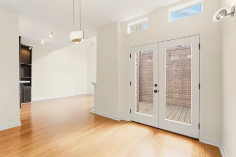 a view of a hallway with wooden floor