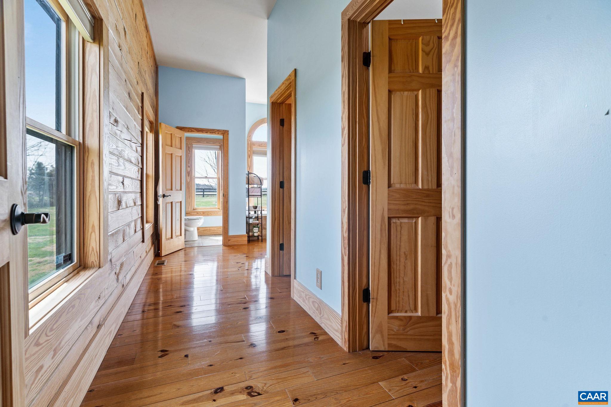 42 River Ridge Lane Stanardsville, VA 22973 - Photo 32 of 70 a view of a hallway with wooden floor and glass door