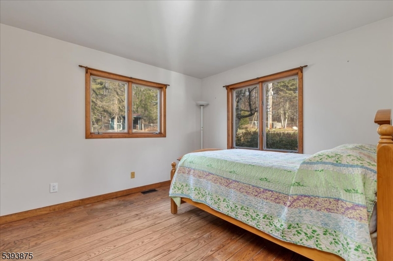 71 Sliker Road Glen Gardner, NJ 08826 - Photo 11 of 50 a bed sitting in a bedroom next to a window