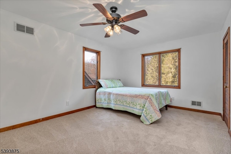 71 Sliker Road Glen Gardner, NJ 08826 - Photo 16 of 50 a spacious bedroom with a bed and a window