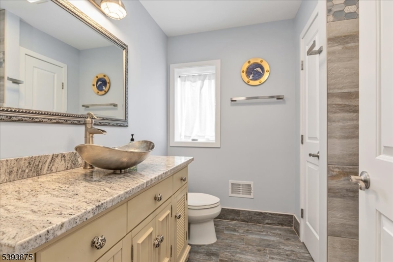 71 Sliker Road Glen Gardner, NJ 08826 - Photo 27 of 50 a bathroom with a granite countertop sink and a mirror