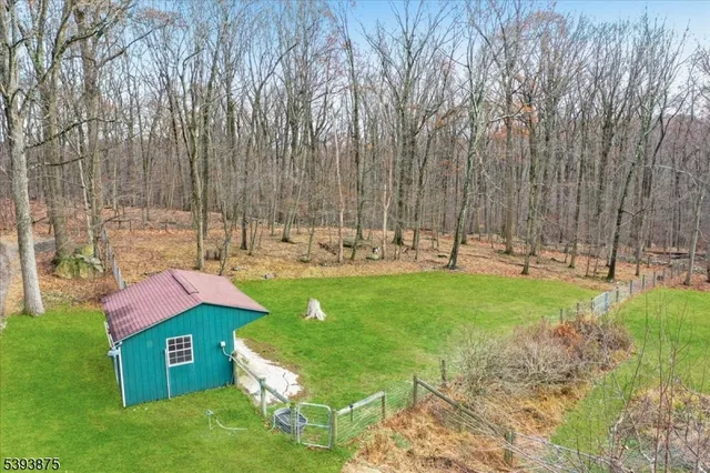 a view of a backyard with large trees