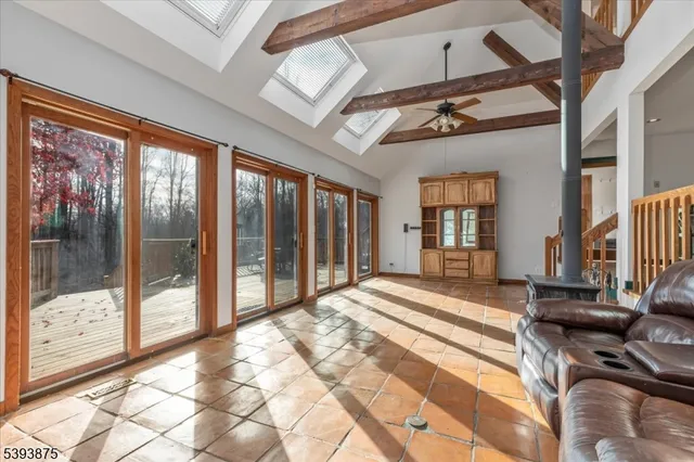 a spacious bedroom with a large bed and a chandelier