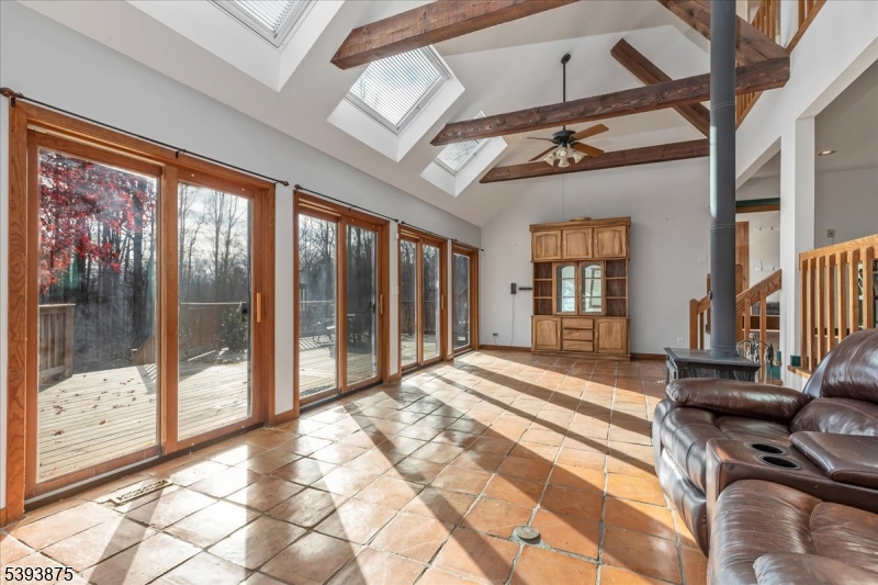 71 Sliker Road Glen Gardner, NJ 08826 - Photo 5 of 50 a spacious bedroom with a large bed and a chandelier
