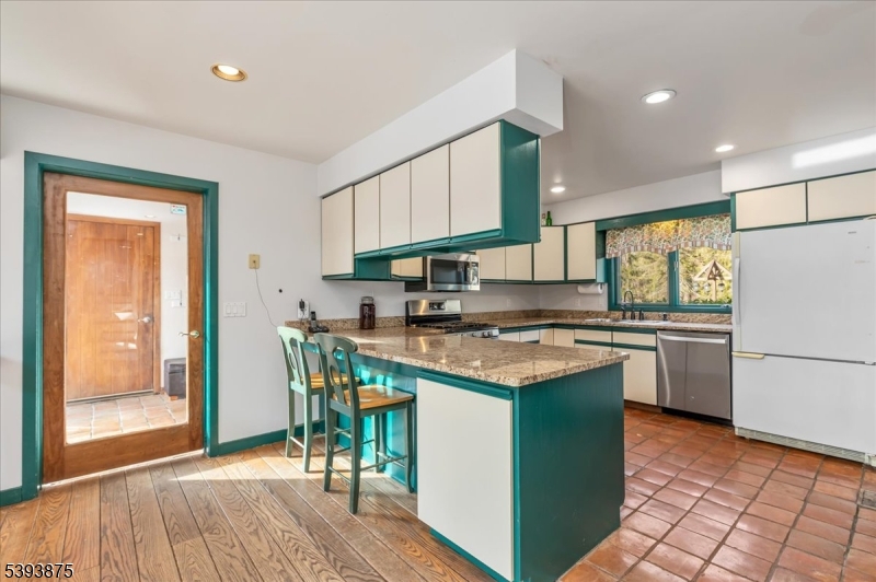 71 Sliker Road Glen Gardner, NJ 08826 - Photo 8 of 50 a kitchen with a stove a sink a refrigerator and a dining table