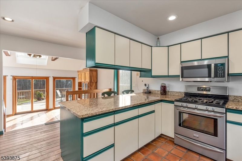 71 Sliker Road Glen Gardner, NJ 08826 - Photo 10 of 50 a kitchen with stainless steel appliances granite countertop a stove a sink and a microwave