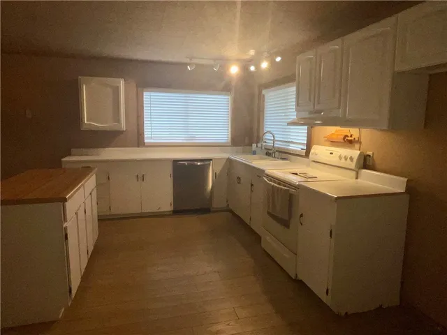 a kitchen with sink cabinets and window