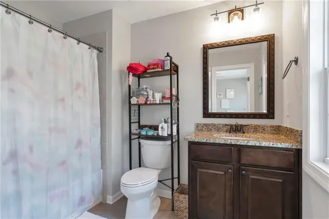 a bathroom with a sink a toilet and mirror
