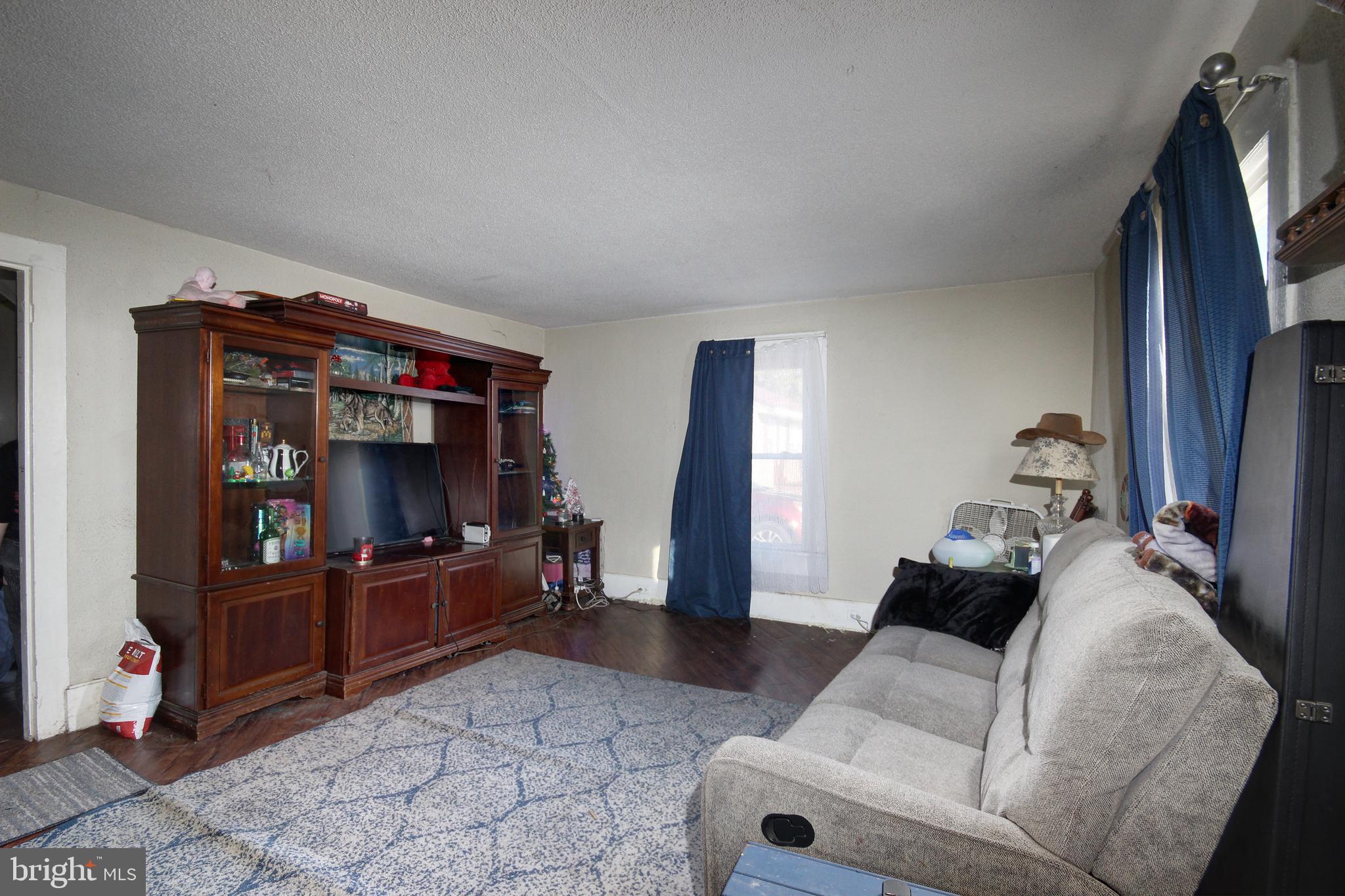 11 West Chestnut Street Delmar, MD 21875 - Photo 3 of 14 a living room with furniture and a flat screen tv