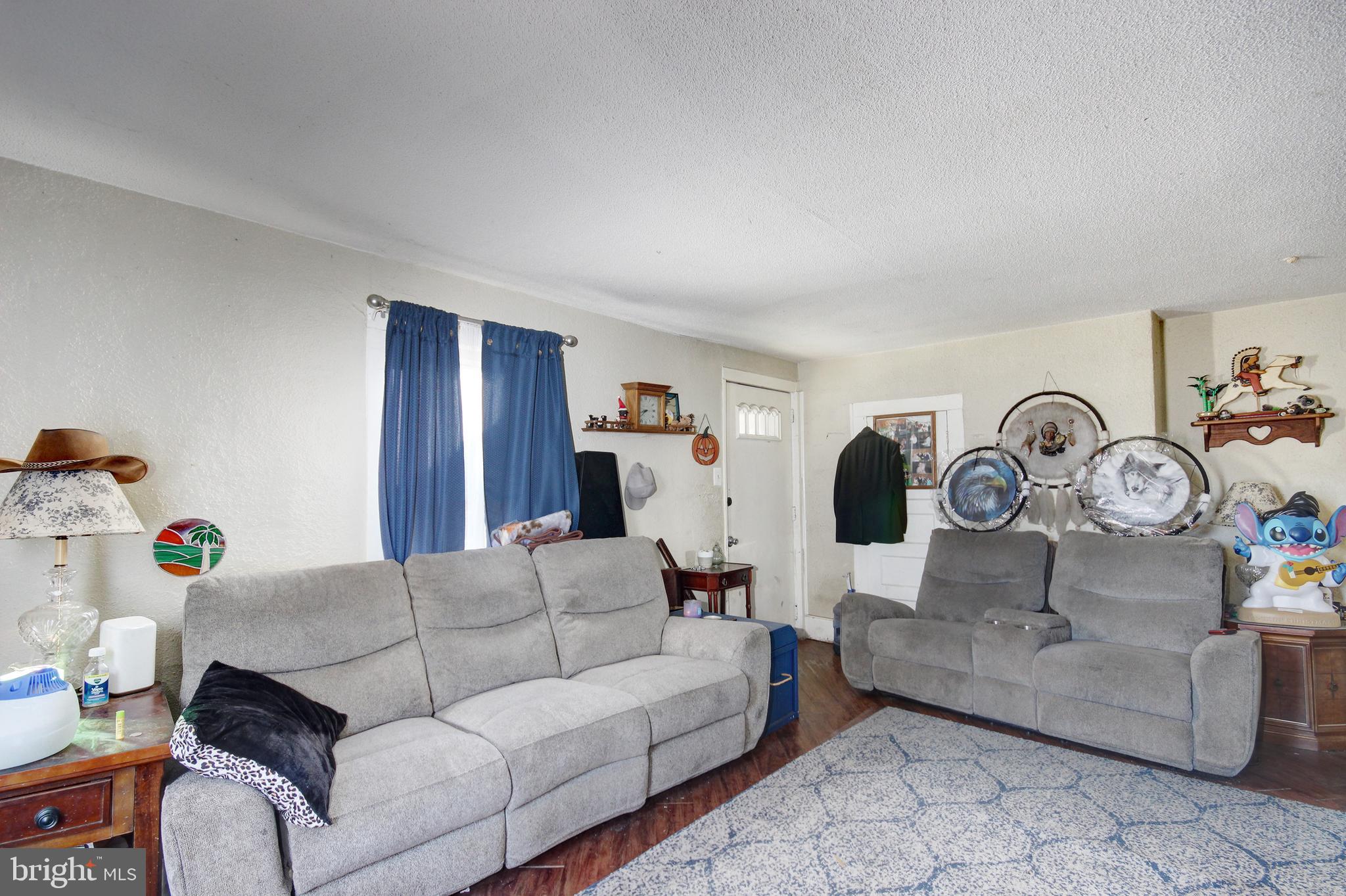 11 West Chestnut Street Delmar, MD 21875 - Photo 4 of 14 a living room with furniture and a clock